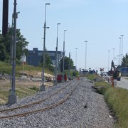 Ny ballast, oriktat spår och kontaktledningsstolpar med belysning längs S. Stillerydsvägen.